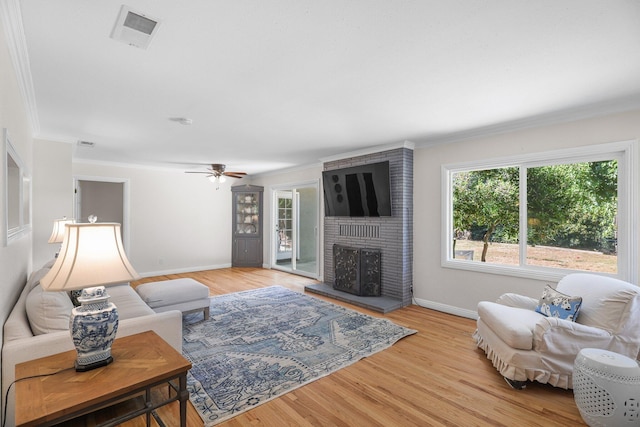 2920 Pioneer Dr, Redding, CA 96001 - living area featuring ornamental molding, a brick fireplace, a ceiling fan, and light wood-style floors