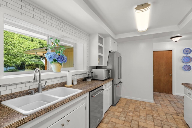 2920 Pioneer Dr, Redding, CA 96001 - kitchen with stainless steel appliances, decorative backsplash, white cabinets, and dark countertops
