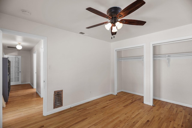 2920 Pioneer Dr, Redding, CA 96001 - unfurnished bedroom with two closets, light wood finished floors, and a ceiling fan