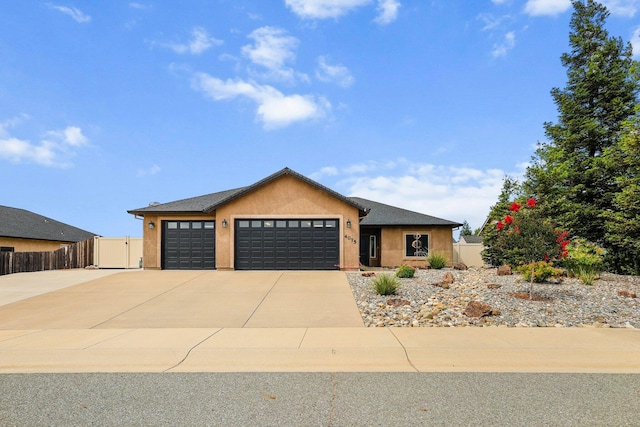4075 Pembroke Ln, Shasta Lake, CA 96019 - view of front facade featuring a garage, stucco siding, and concrete driveway