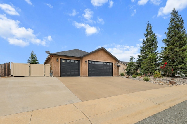 4075 Pembroke Ln, Shasta Lake, CA 96019 - view of front of property featuring a gate, an attached garage, driveway, and stucco siding