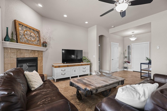 4075 Pembroke Ln, Shasta Lake, CA 96019 - living room featuring ceiling fan, arched walkways, a tiled fireplace, recessed lighting, and light tile patterned floors