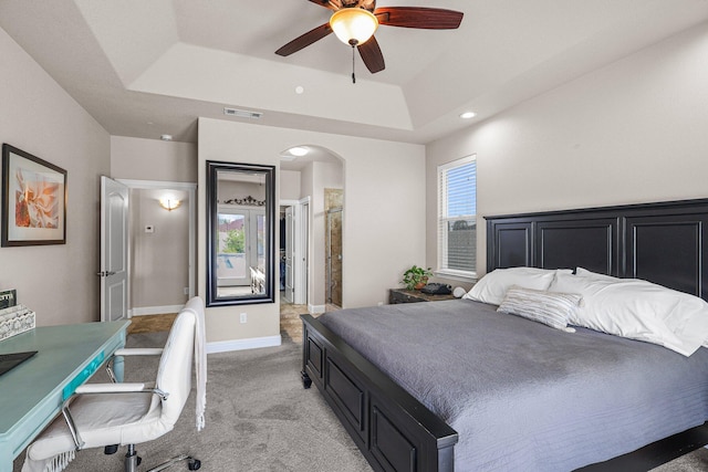 4075 Pembroke Ln, Shasta Lake, CA 96019 - bedroom with a tray ceiling, arched walkways, light colored carpet, recessed lighting, and ceiling fan