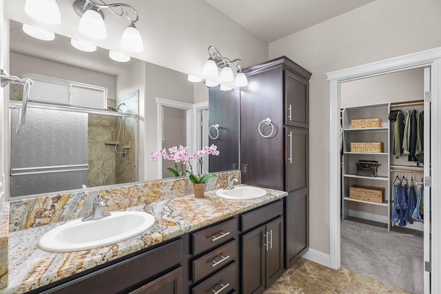 4075 Pembroke Ln, Shasta Lake, CA 96019 - bathroom with double vanity, a spacious closet, and a stall shower