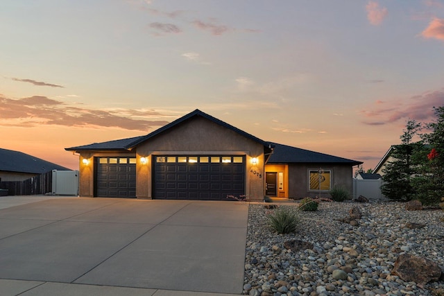 4075 Pembroke Ln, Shasta Lake, CA 96019 - view of front of house featuring an attached garage, concrete driveway, and stucco siding