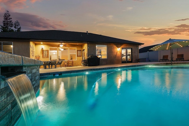 4075 Pembroke Ln, Shasta Lake, CA 96019 - pool at dusk featuring french doors and a patio