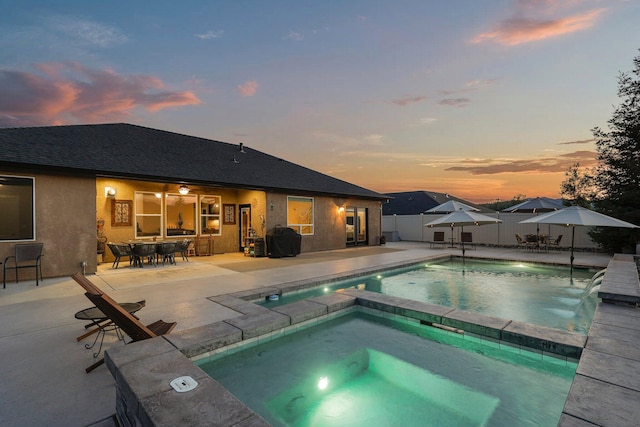 4075 Pembroke Ln, Shasta Lake, CA 96019 - pool at dusk featuring a fenced backyard, a patio area, outdoor dining space, a grill, and a pool with connected hot tub