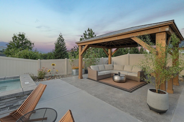 4075 Pembroke Ln, Shasta Lake, CA 96019 - patio terrace at dusk featuring an outdoor hangout area, a gazebo, a patio, and a fenced backyard