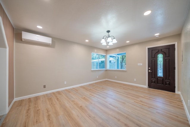 4725 Cedars Rd, Redding, CA 96001 - entryway featuring a wall unit AC, light wood-style floors, recessed lighting, and a chandelier