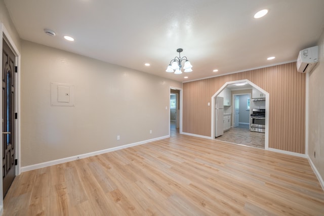 4725 Cedars Rd, Redding, CA 96001 - unfurnished room with arched walkways, light wood-style flooring, a wall mounted air conditioner, electric panel, and recessed lighting