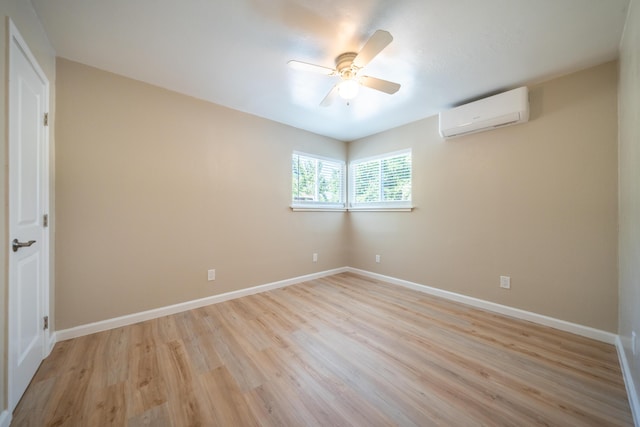 4725 Cedars Rd, Redding, CA 96001 - spare room with a wall mounted air conditioner, ceiling fan, and light wood-style flooring