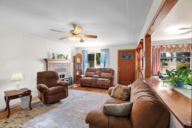 2196 Victor Ave, Redding, CA 96002 - living room featuring wood finished floors, ceiling fan, and a brick fireplace