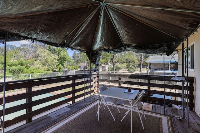 2196 Victor Ave, Redding, CA 96002 - wooden terrace featuring view of wooded area and an exterior structure