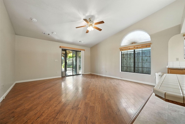 2585 Meadowview Dr, Red Bluff, CA 96080 - unfurnished living room with a ceiling fan, lofted ceiling, wood finished floors, and arched walkways