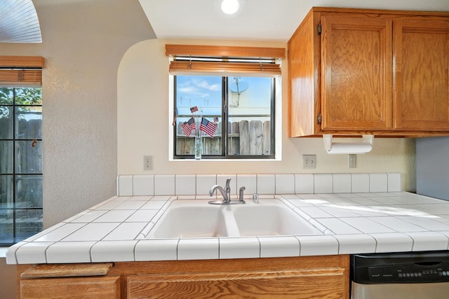 2585 Meadowview Dr, Red Bluff, CA 96080 - kitchen featuring stainless steel dishwasher, tile countertops, and brown cabinets