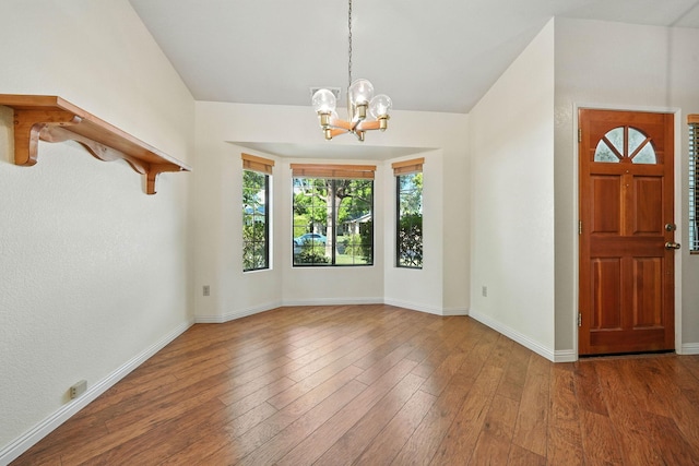 2585 Meadowview Dr, Red Bluff, CA 96080 - entrance foyer with a chandelier, wood finished floors, and vaulted ceiling