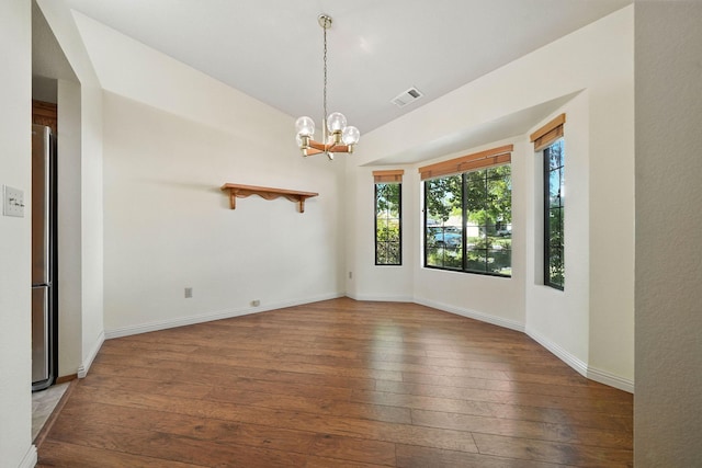 2585 Meadowview Dr, Red Bluff, CA 96080 - empty room featuring hardwood / wood-style flooring, a chandelier, and lofted ceiling