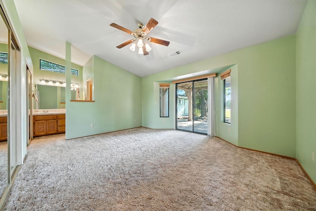 2585 Meadowview Dr, Red Bluff, CA 96080 - unfurnished bedroom with access to exterior, light carpet, vaulted ceiling, connected bathroom, and ceiling fan