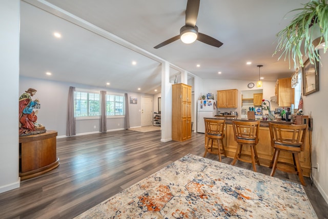 3304 Shasta Dam Blvd Unit 173, Shasta Lake, CA 96019 - kitchen featuring freestanding refrigerator, ceiling fan, dark wood-style floors, dark countertops, and a peninsula