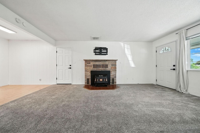 1520 Minor St, Redding, CA 96002 - unfurnished living room featuring carpet floors, a wood stove, and a textured ceiling