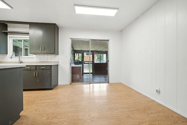 1520 Minor St, Redding, CA 96002 - kitchen featuring light wood-type flooring, light countertops, gray cabinets, and decorative backsplash