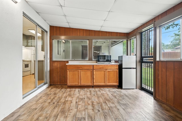 1520 Minor St, Redding, CA 96002 - unfurnished sunroom featuring wood finished floors, wooden walls, a drop ceiling, and a wooden deck