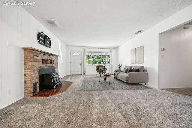1520 Minor St, Redding, CA 96002 - living area featuring a wood stove, carpet flooring, and a textured ceiling