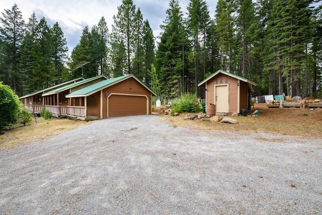 36088 Deer Flat Rd, Shingletown, CA 96088 - detached garage featuring a storage shed and a wooded view