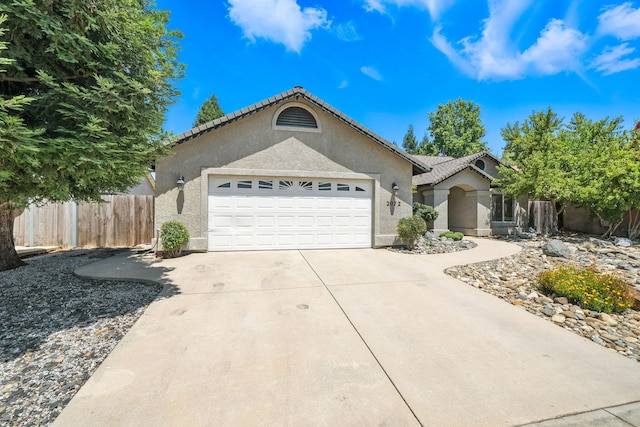 2072 Button Pl, Redding, CA 96002 - ranch-style house with an attached garage, stucco siding, and driveway