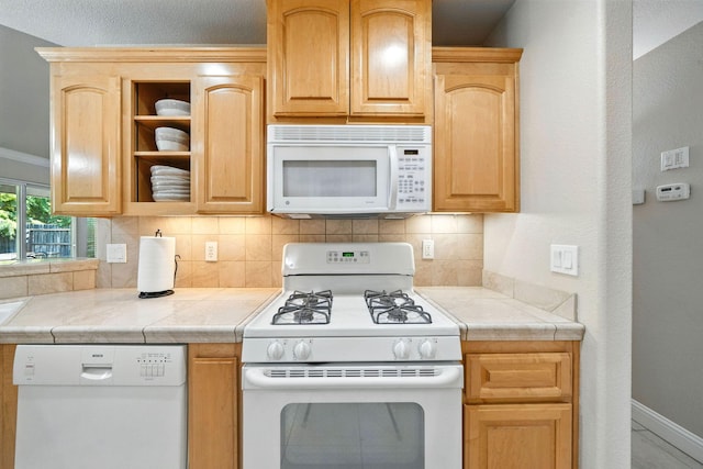 2072 Button Pl, Redding, CA 96002 - kitchen with white appliances, decorative backsplash, light brown cabinetry, and tile countertops