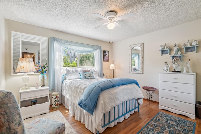 14480 Warren Ave, Red Bluff, CA 96080 - bedroom featuring a textured ceiling, wood finished floors, and ceiling fan