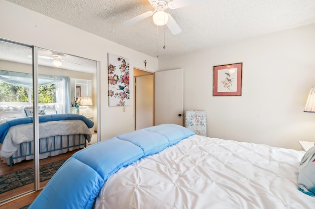 14480 Warren Ave, Red Bluff, CA 96080 - bedroom with a textured ceiling, wood finished floors, a ceiling fan, and a closet