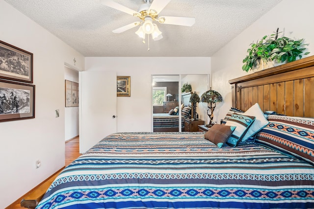 14480 Warren Ave, Red Bluff, CA 96080 - bedroom with a textured ceiling, wood finished floors, and ceiling fan