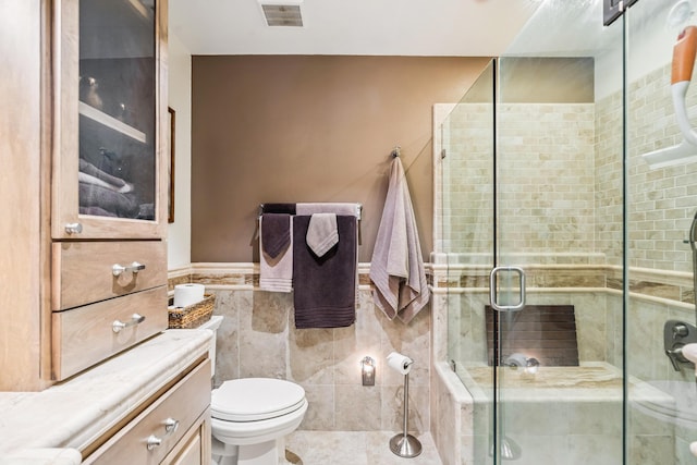 14480 Warren Ave, Red Bluff, CA 96080 - full bathroom featuring tile walls, a stall shower, vanity, and a wainscoted wall