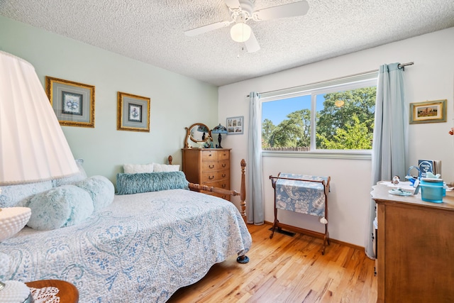 14480 Warren Ave, Red Bluff, CA 96080 - bedroom with light wood-style flooring, a textured ceiling, and ceiling fan
