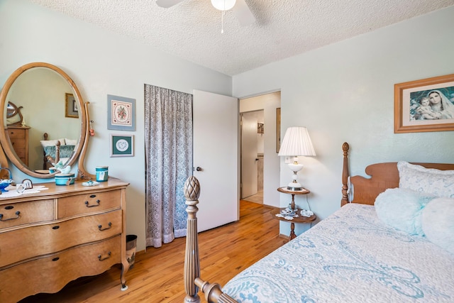 14480 Warren Ave, Red Bluff, CA 96080 - bedroom featuring a textured ceiling, light wood-type flooring, and ceiling fan