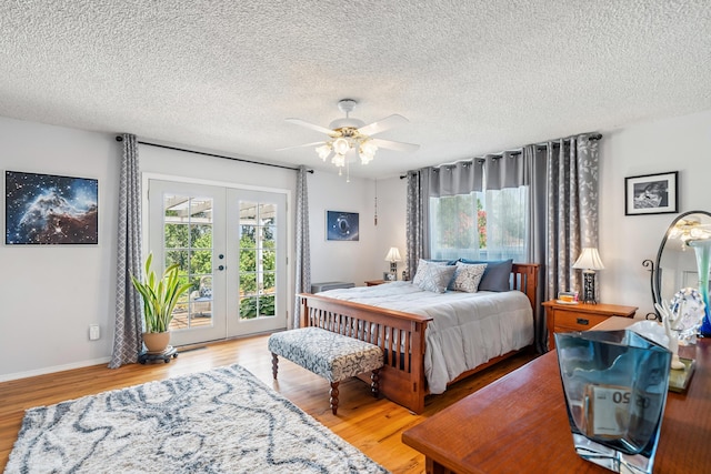14480 Warren Ave, Red Bluff, CA 96080 - bedroom featuring access to outside, french doors, wood finished floors, a textured ceiling, and ceiling fan