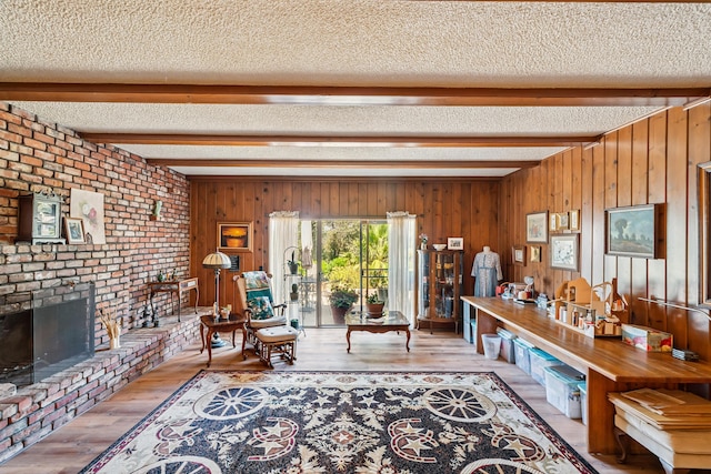 14480 Warren Ave, Red Bluff, CA 96080 - living room with beam ceiling, a textured ceiling, hardwood / wood-style flooring, a fireplace, and wooden walls