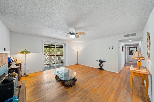 4215 Oro St, Redding, CA 96002 - living room with a ceiling fan, light wood finished floors, and a textured ceiling