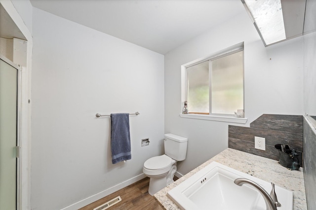 4215 Oro St, Redding, CA 96002 - full bath featuring a shower with door, wood finished floors, and vanity