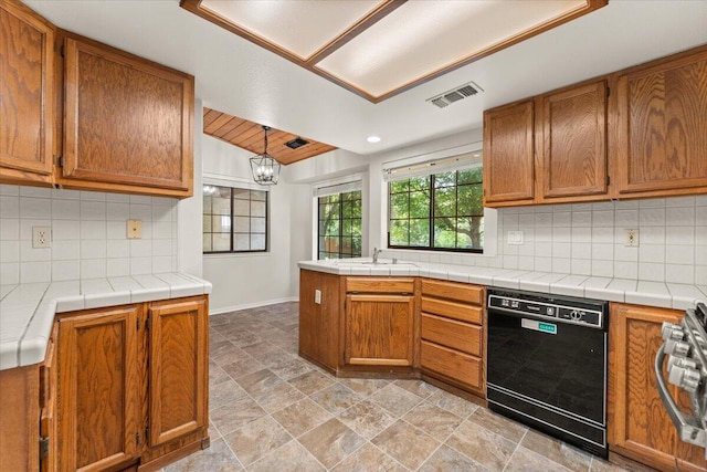 3628 Somerset Ave, Redding, CA 96002 - kitchen featuring dishwasher, brown cabinetry, backsplash, stove, and a chandelier