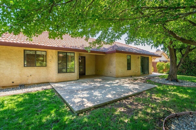 3628 Somerset Ave, Redding, CA 96002 - back of house featuring a tiled roof, stucco siding, and a patio
