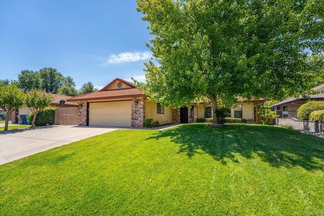 3628 Somerset Ave, Redding, CA 96002 - view of front of house featuring a garage, driveway, a tile roof, and stucco siding