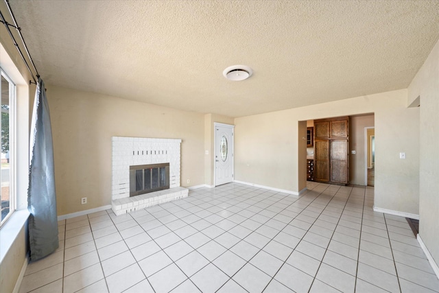 3255 Winding Way, Redding, CA 96003 - unfurnished living room with light tile patterned floors, plenty of natural light, a textured ceiling, and a fireplace