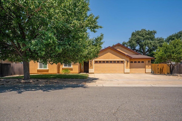2236 Lonigan Ct, Redding, CA 96001 - view of front facade featuring an attached garage, concrete driveway, and stucco siding