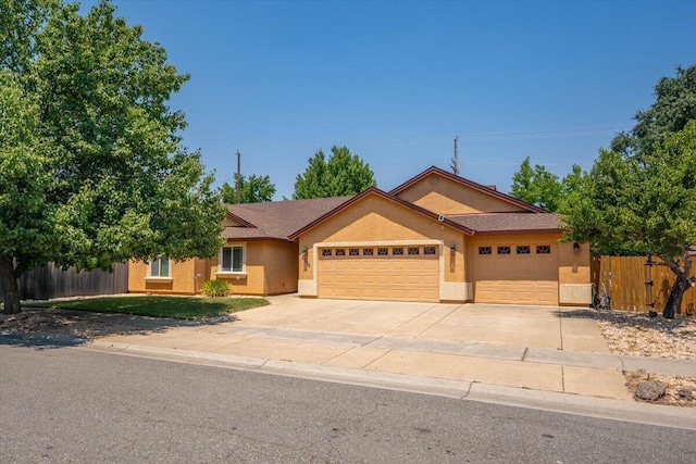 2236 Lonigan Ct, Redding, CA 96001 - ranch-style home with an attached garage, driveway, and stucco siding