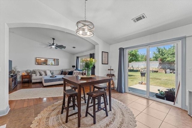 2236 Lonigan Ct, Redding, CA 96001 - dining space featuring lofted ceiling, light tile patterned floors, ceiling fan, arched walkways, and a chandelier