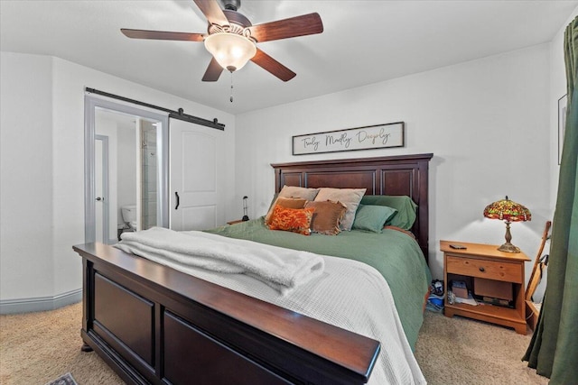 2236 Lonigan Ct, Redding, CA 96001 - bedroom with light carpet, a barn door, and a ceiling fan