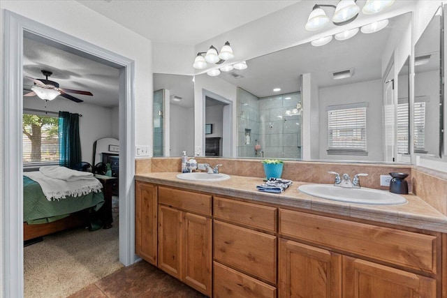 2236 Lonigan Ct, Redding, CA 96001 - ensuite bathroom featuring a shower stall, double vanity, ceiling fan, and tile patterned floors