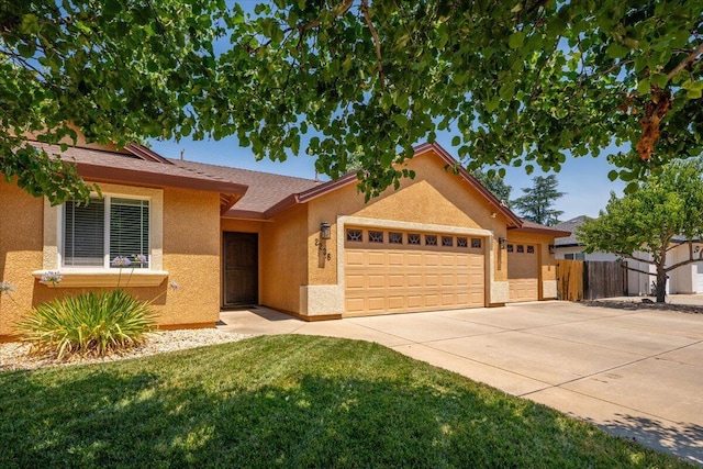 2236 Lonigan Ct, Redding, CA 96001 - ranch-style home featuring an attached garage, driveway, and stucco siding